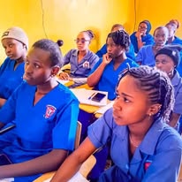 KCT students in blue uniforms in a classroom session, alternative view